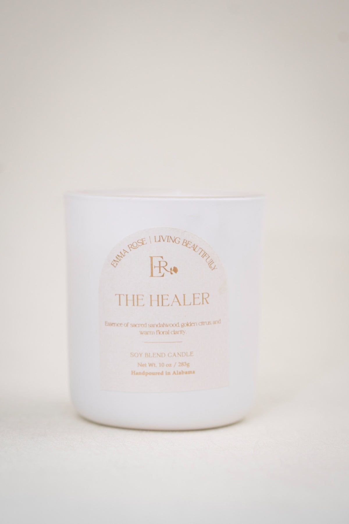 The Healer 10 oz luxury sandalwood candle in a white vessel
