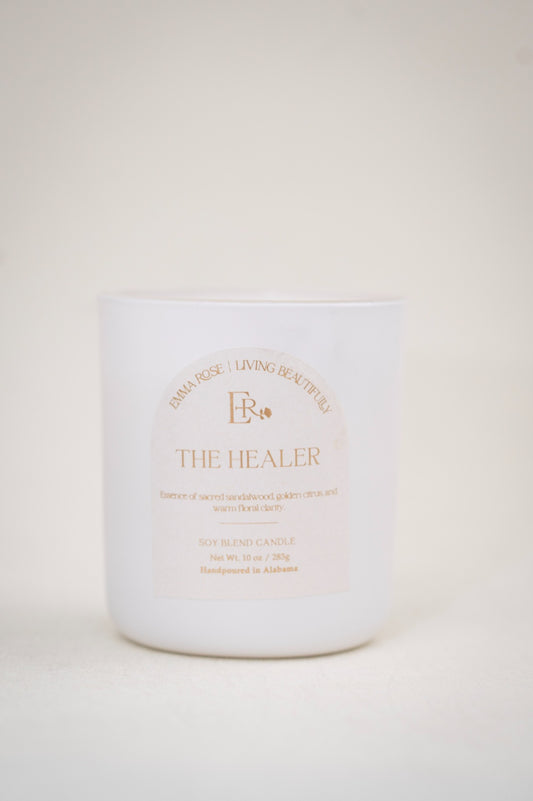 The Healer 10 oz luxury sandalwood candle in a white vessel